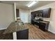 Kitchen featuring dark wood cabinets, stainless steel appliances and granite countertops at 203 August West Way, Lawrenceville, GA 30046