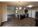 Open concept kitchen featuring dark wood cabinets and stainless steel appliances at 203 August West Way, Lawrenceville, GA 30046