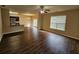 Open concept living room with wood floors and windows allowing for natural light to enter the room at 203 August West Way, Lawrenceville, GA 30046