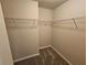 Walk-in closet with carpeted floors and wire shelving at 203 August West Way, Lawrenceville, GA 30046