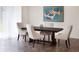 Modern dining room featuring a wood table, four upholstered chairs, modern lighting and luxury vinyl plank flooring at 45 Champions Blvd, Dallas, GA 30157