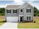 Charming two-story home with gray siding, black shutters, and a well-manicured lawn in a suburban setting at 45 Champions Blvd, Dallas, GA 30157