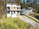 Aerial view of a modern home with unique design, ample yard, and covered parking at 1045 Shepherds Ne Ln, Atlanta, GA 30324