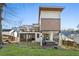 Modern home with backyard showcasing patio, deck, hot tub, and green lawn at 1045 Shepherds Ne Ln, Atlanta, GA 30324