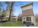 Green backyard, deck, and a hot tub with exterior view of the modern home at 1045 Shepherds Ne Ln, Atlanta, GA 30324
