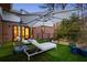 Outdoor space with artificial turf, sun loungers, a modern patio umbrella, and stylish blue planters at 1045 Shepherds Ne Ln, Atlanta, GA 30324