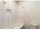 Clean bathroom featuring a white tiled shower and toilet at 1045 Shepherds Ne Ln, Atlanta, GA 30324