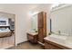 Bright bathroom featuring double sinks, modern fixtures, and wood cabinets near the bedroom at 1045 Shepherds Ne Ln, Atlanta, GA 30324