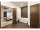 Bright bathroom with a modern soaking tub, stylish tile work, and an attached bedroom space at 1045 Shepherds Ne Ln, Atlanta, GA 30324