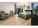 Comfortable bedroom featuring a bed, leather chair, and large windows overlooking a green landscape at 1045 Shepherds Ne Ln, Atlanta, GA 30324
