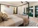 Bright bedroom with an outdoor view, featuring a four-poster bed and neutral decor at 1045 Shepherds Ne Ln, Atlanta, GA 30324