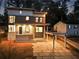 Beautifully lit modern home with sleek architectural design, featuring a carport and patterned stone driveway at 1045 Shepherds Ne Ln, Atlanta, GA 30324