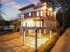 Modern home at twilight, showcasing a well-lit exterior, clean lines, and stylish design elements at 1045 Shepherds Ne Ln, Atlanta, GA 30324