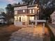 Charming two-story home with a modern design, well-lit exterior, and a stone driveway leading up to the house at 1045 Shepherds Ne Ln, Atlanta, GA 30324