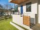 Contemporary home's entryway with a blue front door, minimalist railing, and modern landscaping at 1045 Shepherds Ne Ln, Atlanta, GA 30324