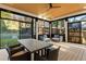 Screened porch featuring a ceiling fan, comfortable seating, and dining area at 1045 Shepherds Ne Ln, Atlanta, GA 30324