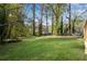 Expansive backyard with mature trees, offering ample space for recreation and relaxation at 2072 Baker Nw Rd, Atlanta, GA 30318