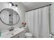 Clean bathroom featuring a sink, toilet, shower and a storage unit at 2072 Baker Nw Rd, Atlanta, GA 30318