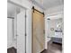 Bathroom and bedroom featuring a barn door, tile floors, and neutral paint at 2072 Baker Nw Rd, Atlanta, GA 30318