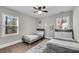 Bedroom with two twin beds, neutral paint, a ceiling fan and hardwood floors at 2072 Baker Nw Rd, Atlanta, GA 30318