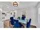 Bright dining room featuring modern table and chairs with adjacent kitchen with white cabinets at 2072 Baker Nw Rd, Atlanta, GA 30318