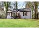 Attractive single-Gathering home with lush green lawn, wood accents, and a cozy entrance at 2072 Baker Nw Rd, Atlanta, GA 30318