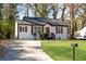 Inviting home with a well-kept lawn, a curved driveway, and rustic wood accents at 2072 Baker Nw Rd, Atlanta, GA 30318