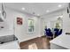 Modern kitchen featuring white cabinetry and a dining area with stylish blue chairs at 2072 Baker Nw Rd, Atlanta, GA 30318
