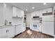 Well-lit kitchen featuring modern appliances, white cabinets, and sleek countertops at 2072 Baker Nw Rd, Atlanta, GA 30318