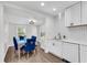 Updated kitchen with white cabinets, herringbone backsplash, and an adjacent dining space at 2072 Baker Nw Rd, Atlanta, GA 30318