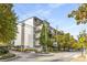 Modern condo complex exterior with multiple balconies and lush green trees at 3400 Malone Dr # 110, Atlanta, GA 30341