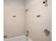 Bathroom shower featuring white tiled walls with decorative accents at 3400 Malone Dr # 110, Atlanta, GA 30341