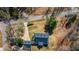 An aerial view of a home with a long driveway, set back off the road, with a dark grey roof at 6510 Akins Way, Cumming, GA 30041