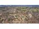 A beautiful aerial view of a neighborhood in the distance with rolling hills on the horizon at 6510 Akins Way, Cumming, GA 30041