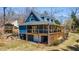 Charming blue two-story home with a spacious deck and manicured lawn at 6510 Akins Way, Cumming, GA 30041