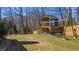 Backyard featuring a stylish playhouse, swing, and outdoor seating area at 6510 Akins Way, Cumming, GA 30041