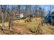 Large backyard with a playhouse, slide, and partially fenced perimeter at 6510 Akins Way, Cumming, GA 30041