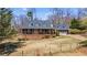 Charming two-story home with a welcoming front porch and well-maintained landscaping and matching detached garage at 6510 Akins Way, Cumming, GA 30041