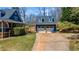Charming blue home with a detached garage and well-maintained driveway at 6510 Akins Way, Cumming, GA 30041