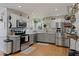 Modern kitchen with stainless steel appliances, granite countertops, and ample cabinet space, perfect for cooking and entertaining at 6510 Akins Way, Cumming, GA 30041