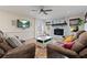 Cozy living room with a stone fireplace, plush seating, and a large TV, ideal for relaxation and entertainment at 6510 Akins Way, Cumming, GA 30041