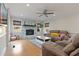 Living room with a fireplace, hardwood floors, large sofa, and a ceiling fan at 6510 Akins Way, Cumming, GA 30041