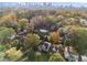 Aerial view of neighborhood with mature trees and city skyline in the distance at 1824 Windemere Ne Dr, Atlanta, GA 30324