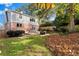 Expansive backyard with patio, outdoor dining, mature trees, and privacy fence at 1824 Windemere Ne Dr, Atlanta, GA 30324