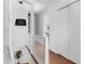 Bright hallway with hardwood floors, white railings, and a modern chandelier, leading to the upper level at 1824 Windemere Ne Dr, Atlanta, GA 30324