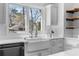 Bright kitchen featuring white countertops, a farmhouse sink, open shelving, and stainless appliances at 1824 Windemere Ne Dr, Atlanta, GA 30324