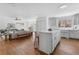 Open-concept kitchen with island flows into a living room with white walls and hardwood floors at 1824 Windemere Ne Dr, Atlanta, GA 30324