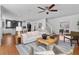 Bright living room featuring a ceiling fan, hardwood floors, and stairs to the upper level at 1824 Windemere Ne Dr, Atlanta, GA 30324