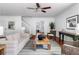 Inviting living room featuring a staircase, neutral decor, and a view into another room at 1824 Windemere Ne Dr, Atlanta, GA 30324