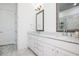 Bright bathroom with double vanity, marble countertop, and a framed mirror at 2119 Dee Dee Muse Nw Ln, Atlanta, GA 30318